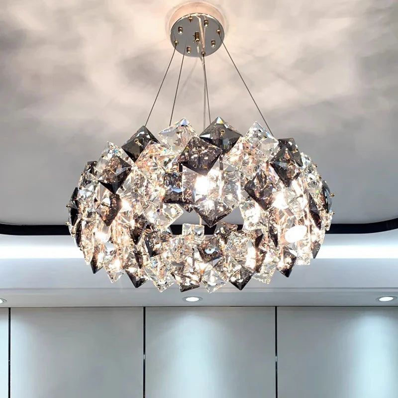 Geometric diamond crystal LED chandelier in modern stainless steel, creates sparkling light patterns.
