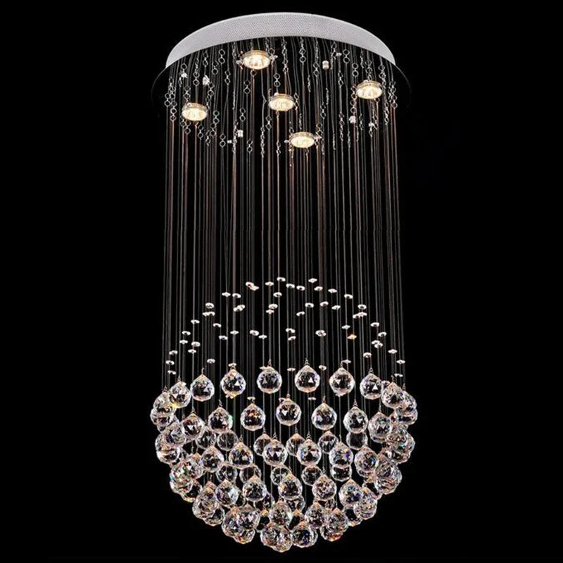 Polished steel chandelier with cascading modern crystal pendants, circular mount, and LED illumination.