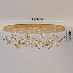 Gold oval chandelier with hanging crystal floral accents and LED lights, 120x40 cm.