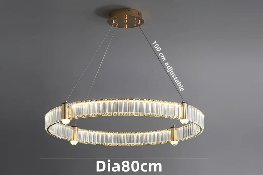 Gold crystal chandelier with LED rings, visible bulbs, and adjustable wires; modern product-focused design.