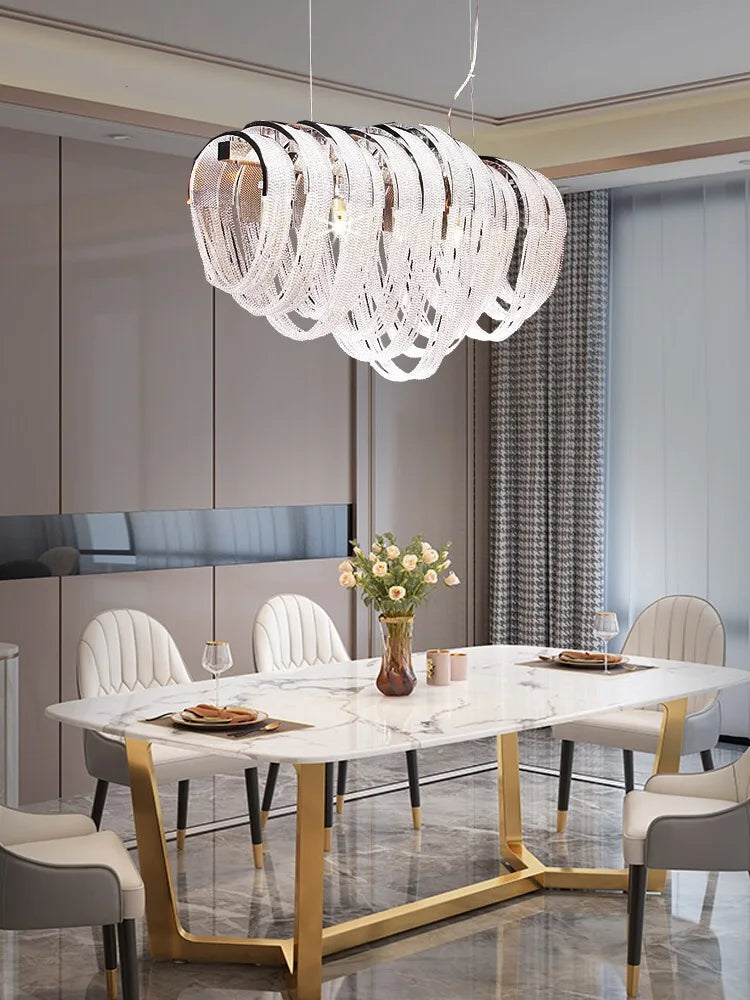 Maison Ornate’s Modern Nordic Crystal Chandelier with LED Tassels and curved crystal-like elements.