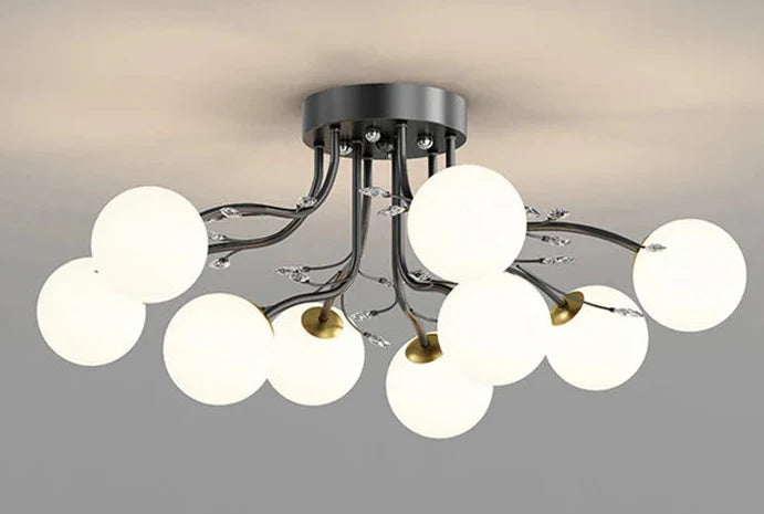Sleek black chandelier with curved arms, clear globes, and LED stars for modern elegance.