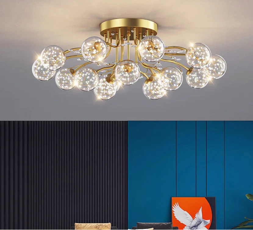 Maison Ornate Crystal Ball Chandelier with LED stars, golden arms, and clear glass bulbs illuminated.