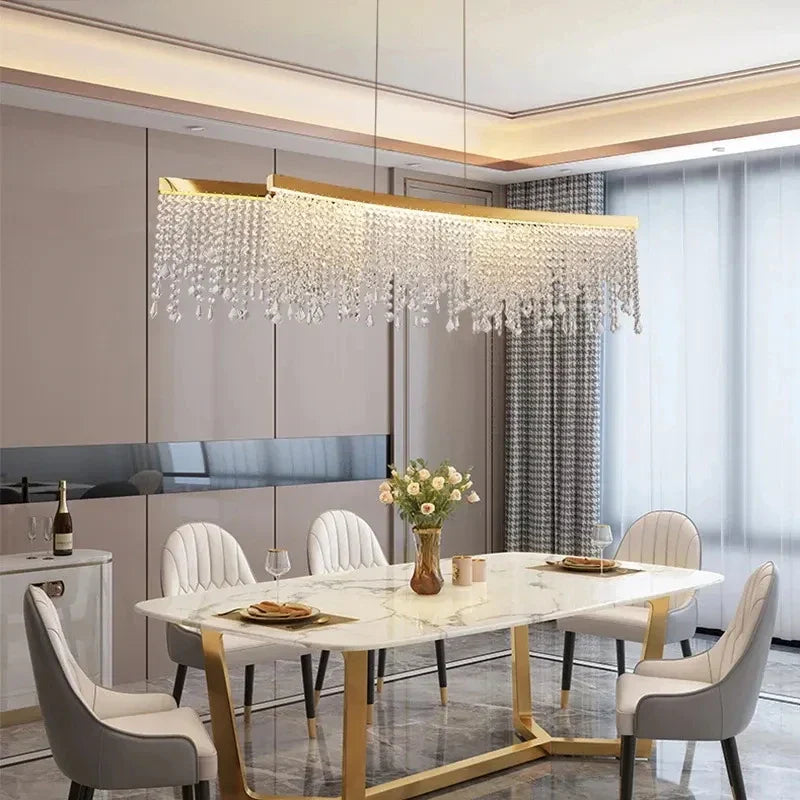 Maison Ornate’s Modern Crystal Chandelier features gold round pendants, glass crystals, and sleek metallic accents.
