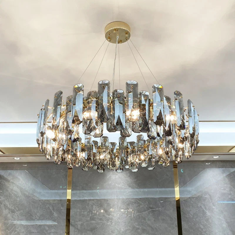 Modern crystal LED chandelier with prisms on thin wires, gold circular base, elegant lighting.