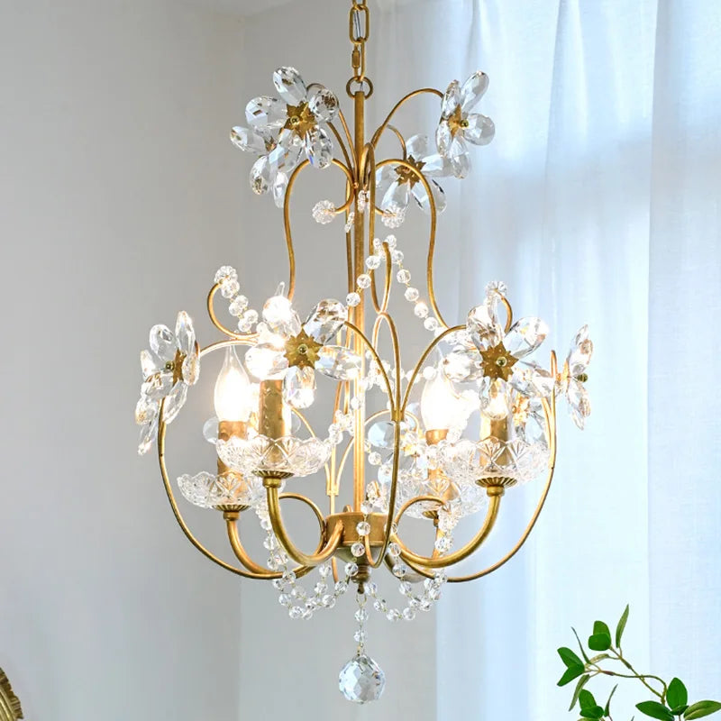 Ornate gold hallway chandelier with curved arms, crystal flowers, and hanging crystal ornaments.