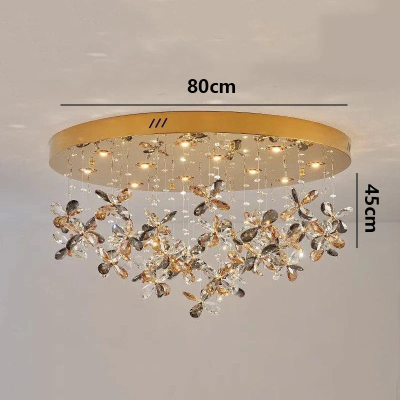 Metal and crystal chandelier with floral accents and warm LED lights, elegant modern design.