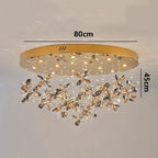Metal and crystal chandelier with floral accents and warm LED lights, elegant modern design.