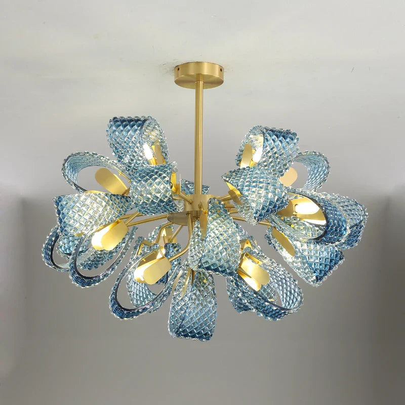 Curved textured blue glass forms a floral starburst LED chandelier with golden accents.