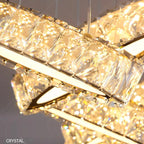 Modern crystal chandelier with circular bands, large faceted crystals, and warm LED sparkle.