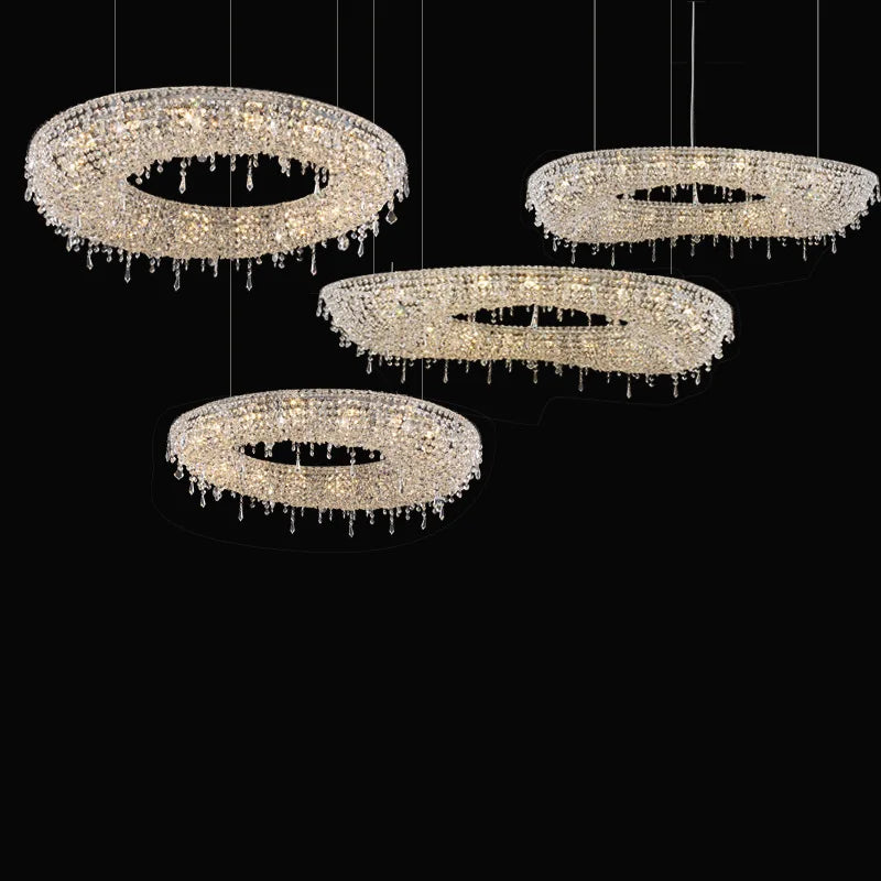 Set of four Maison Ornate luxury crystal LED chandeliers hanging at multiple heights, sparkling elegantly.