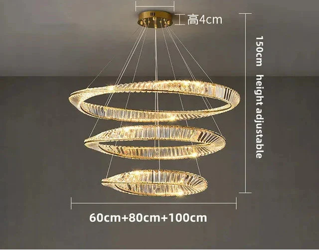 Gold crystal chandelier with three spiral rings, remote control, adjustable height, emits elegant warm light.