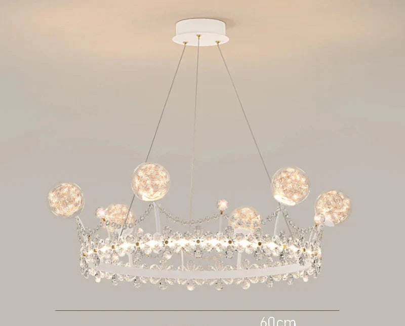 Crown-shaped crystal ball chandelier with sparkling accents and round lights on slim wires.