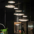 Seven Maison ornate crystal chandeliers with minimalist design and LEDs hang at varying heights.