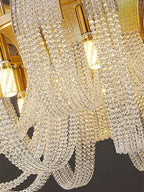 Close-up of Maison Ornate Modern Nordic Crystal Chandelier, golden fixtures and LED-lit crystal strands.