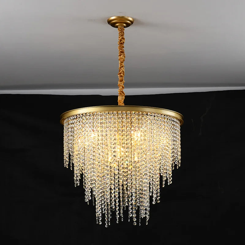 Maison Ornate Modern Crystal Chandelier with gold chain and cascading crystal prisms sparkling brightly.