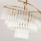 Cascading clear glass rods and gold frame chandelier, elegant modern crystal pendant lighting.