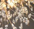 Close-up of Maison Ornate LED pendant light with gold rods and clear acrylic crystals aglow.