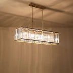 Modern rectangular LED crystal chandelier with gold accents and glass panels, suspended by twin rods.