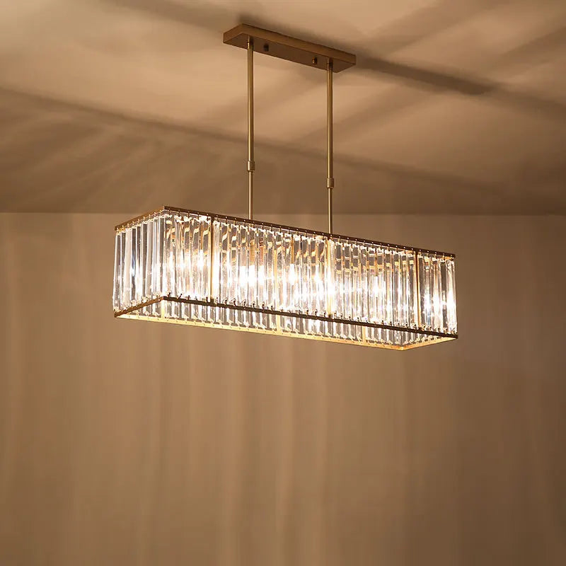 Modern rectangular LED crystal chandelier with gold accents and glass panels, suspended by twin rods.