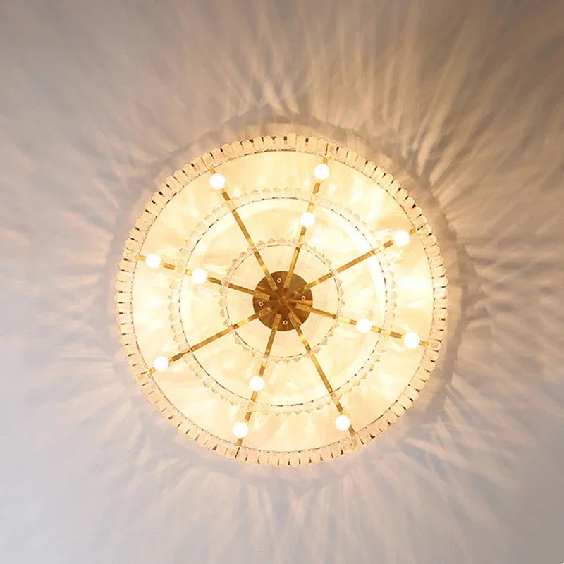 Elegant geometric crystal chandelier with multiple bulbs, featuring sparkling crystal accents and warm light.