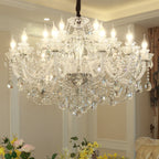 The Maison Ornate Large Crystal Chandelier sparkles from the ceiling with shining, reflective crystals.