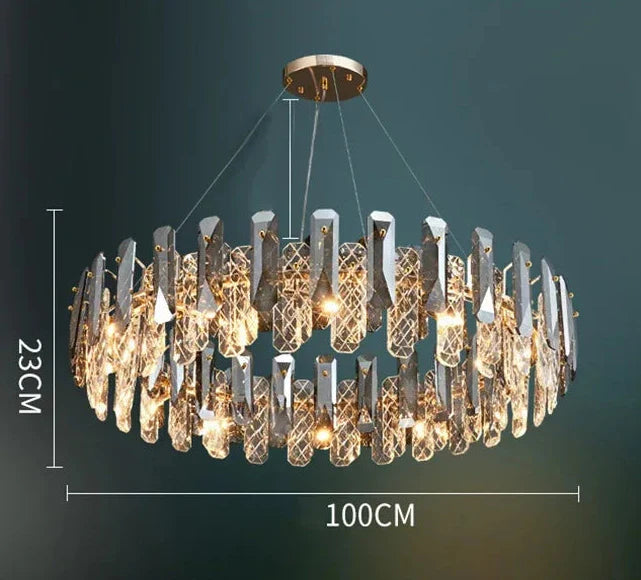 Oval chandelier, 100 cm by 23 cm, with geometric crystals arranged for a warm glowing light.