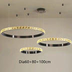 Set of three round Maison Ornate crystal chandeliers with black frames, gold accents, varying diameters.