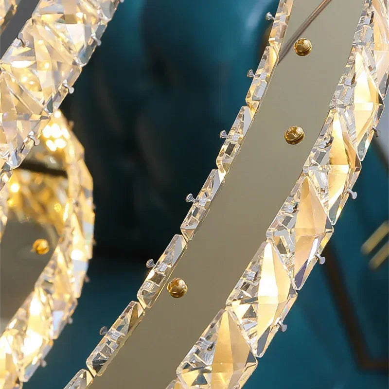 Industrial Crystal Chandelier by Maison Ornate with circular metallic frame, modern pendants, and faceted crystals.