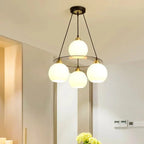 The Maison Ornate Modern Crystal Chandelier with three round heads on black rods, contemporary design.