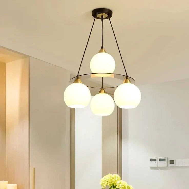 The Maison Ornate Modern Crystal Chandelier with three round heads on black rods, contemporary design.