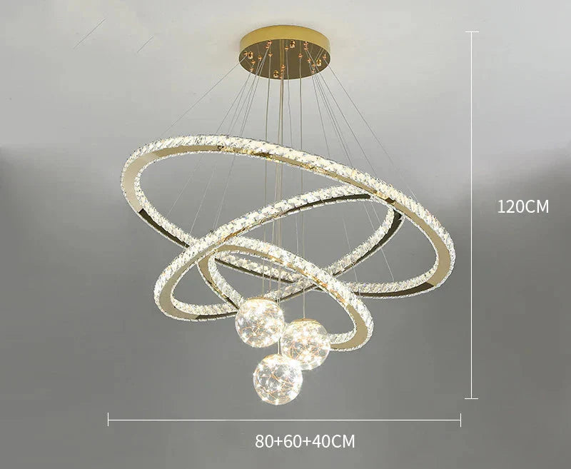 Luxury Maison chandelier with three golden crystal LED rings and four glass balls, 120 cm high.