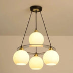 Modern Crystal Chandelier with three round heads, black supports, and a circular base. Warm glow.
