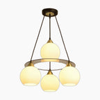 Modern crystal chandelier with three round lights on a circular frame, black rods, and mount.