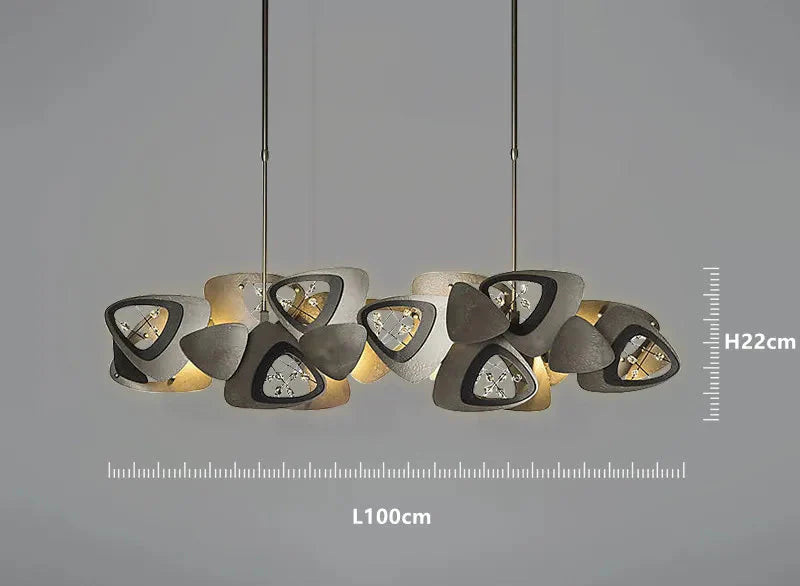 Postmodern crystal ball chandelier with two rows of abstract black and white triangular shades.