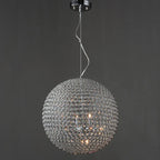 Maison Ornate Round Crystal Ball LED chandelier with glass circle lattice, emitting a warm glow.