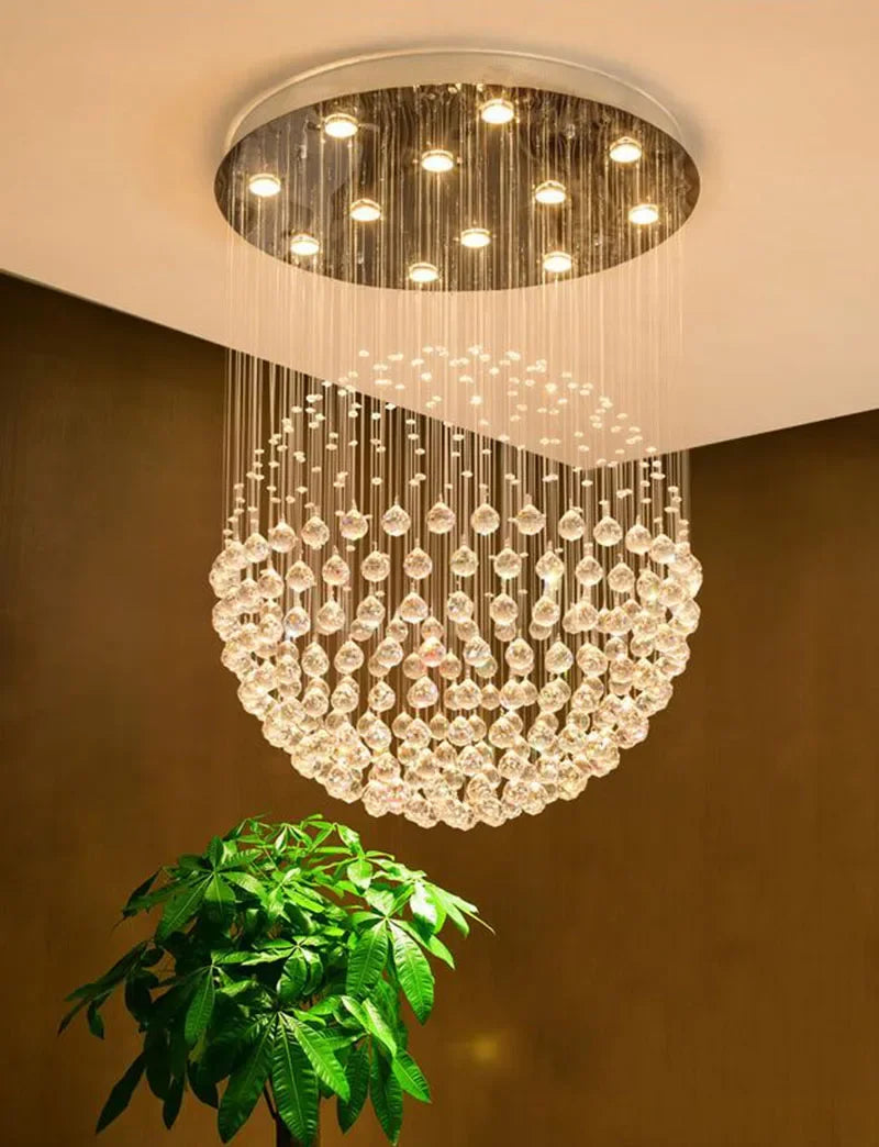 Polished steel chandelier with spherical hanging crystals and LED lights on round ceiling mount.