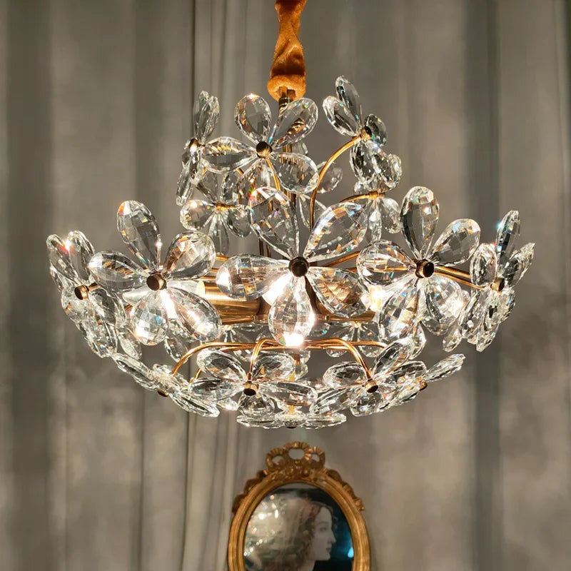 Luxury French crystal glass flower LED chandelier by Maison Ornate, clear floral crystal petals, glowing warmly overhead.