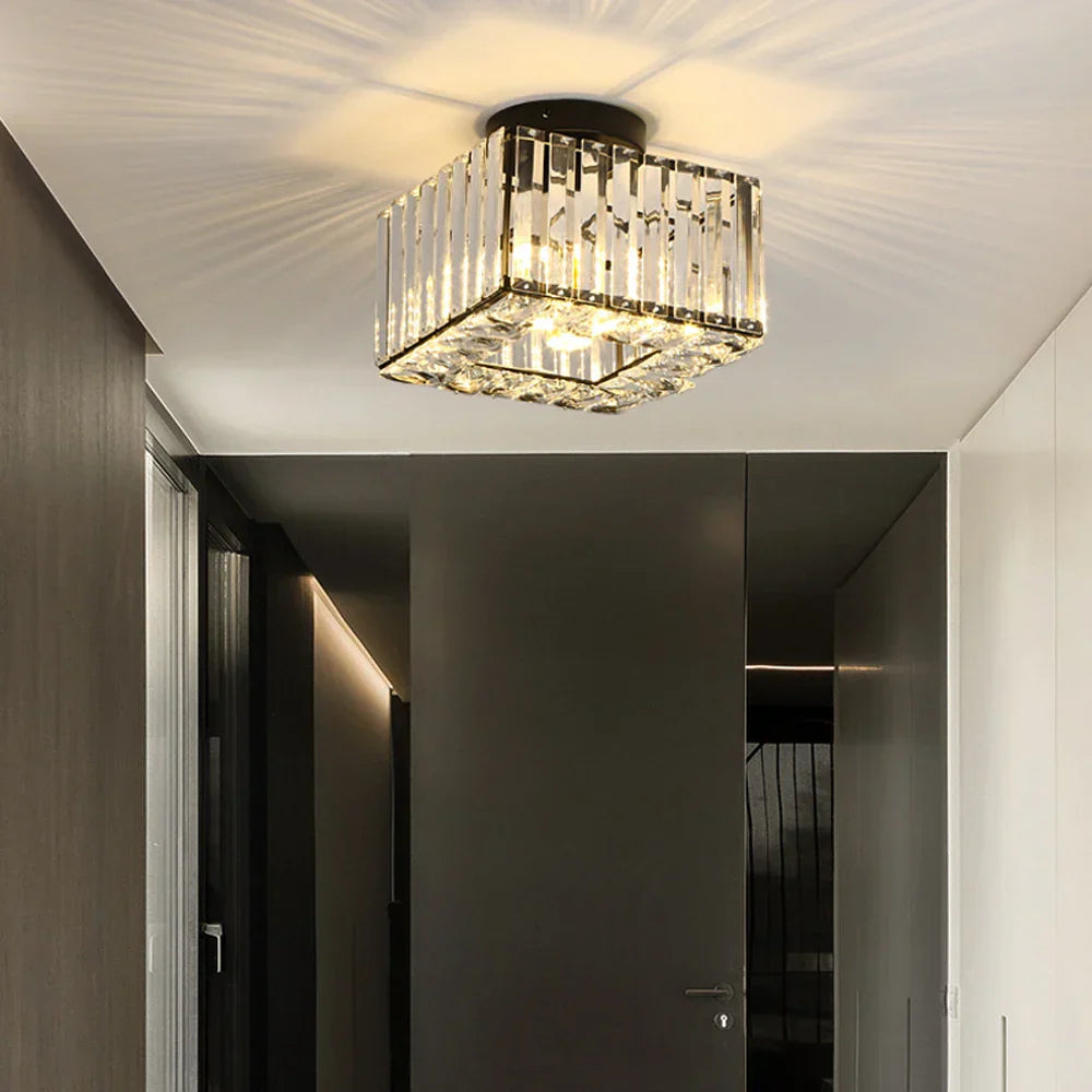 Maison Ornate Modern Square Crystal Glass LED chandelier emits warm glow and elegant ceiling patterns.