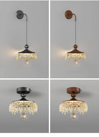 Set of four ornate French medieval chandeliers with teardrop crystals, black/brown canopies, warm lighting.