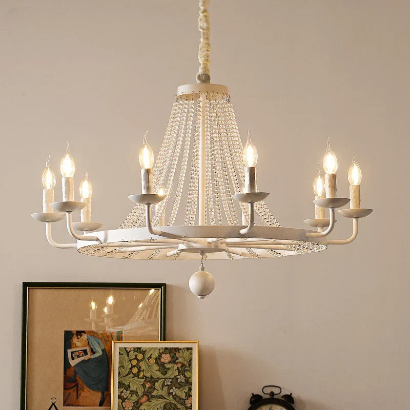 Elegant crystal chandelier with tassels, gold accents, eight candle bulbs, and sparkling crystal beads.