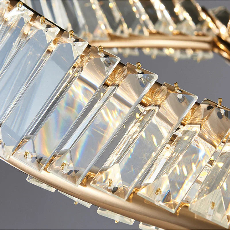 Close-up of Maison Ornate Industrial Crystal Chandelier with faceted prisms reflecting rainbow LED light.