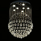 Polished steel chandelier with LED-lit crystal droplets suspended from thin wires, modern and sparkling.