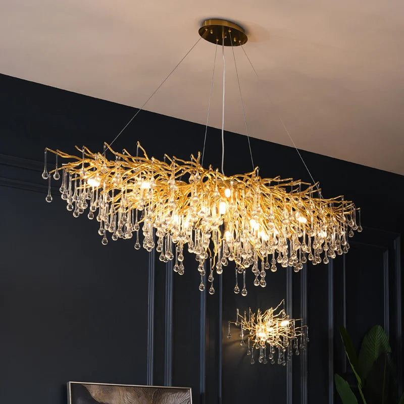 Maison Ornate Crystal Chandelier with gold branches and glass droplets, suspended elegantly from wires.