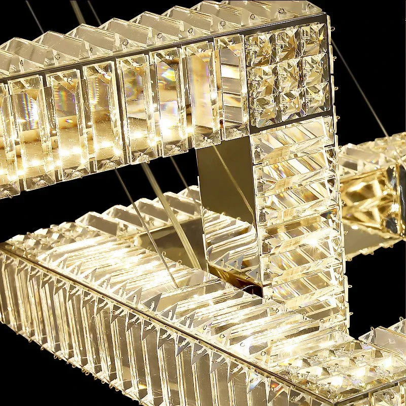 Modern square gold crystal pendant chandelier with rectangular segments and integrated LED lighting, sparkling effect.