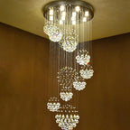 Spiral chandelier with crystal spheres, stainless steel mount, and integrated small lights for elegant illumination.