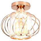 Modern industrial chandelier with rose gold base, caged curved metal wires, and clear glass shade.