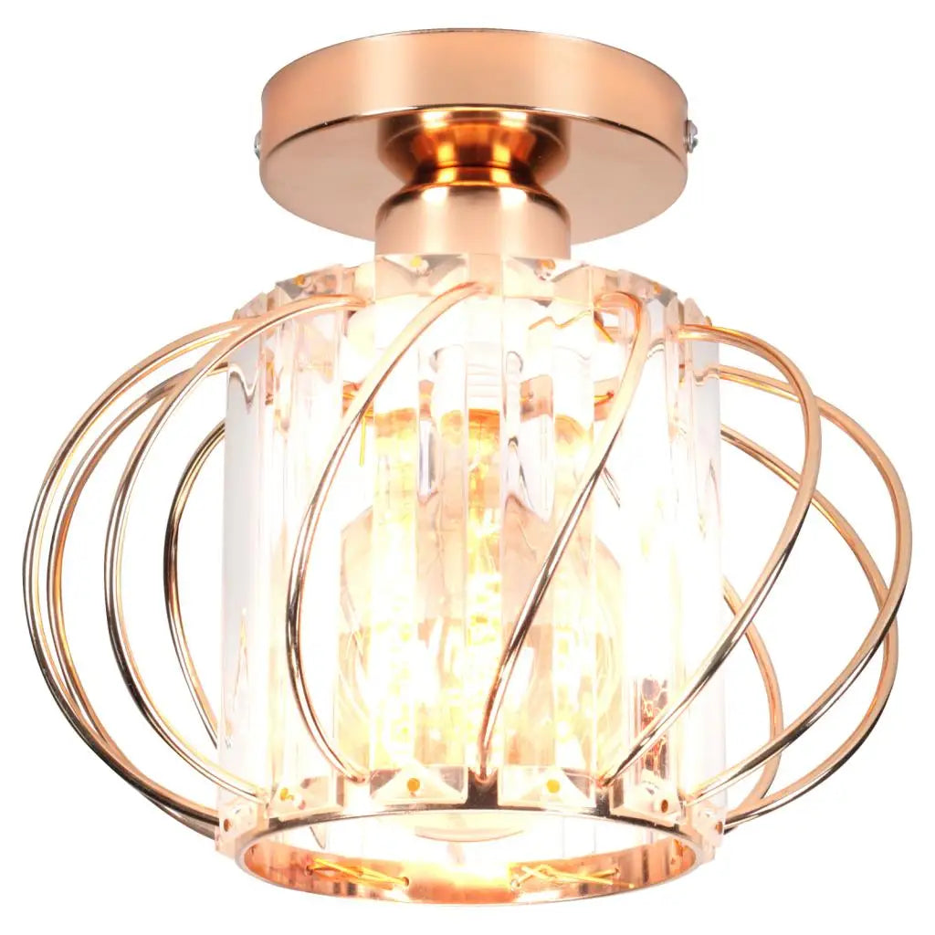 Modern industrial chandelier with rose gold base, caged curved metal wires, and clear glass shade.