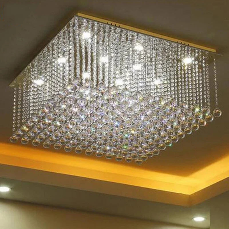 Square chrome chandelier with cascading crystal balls, LED lights emitting bright white and warm yellow glow.