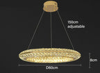 Modern circular crystal LED chandelier with adjustable suspension, warm yellow glow, luxury hotel lighting.